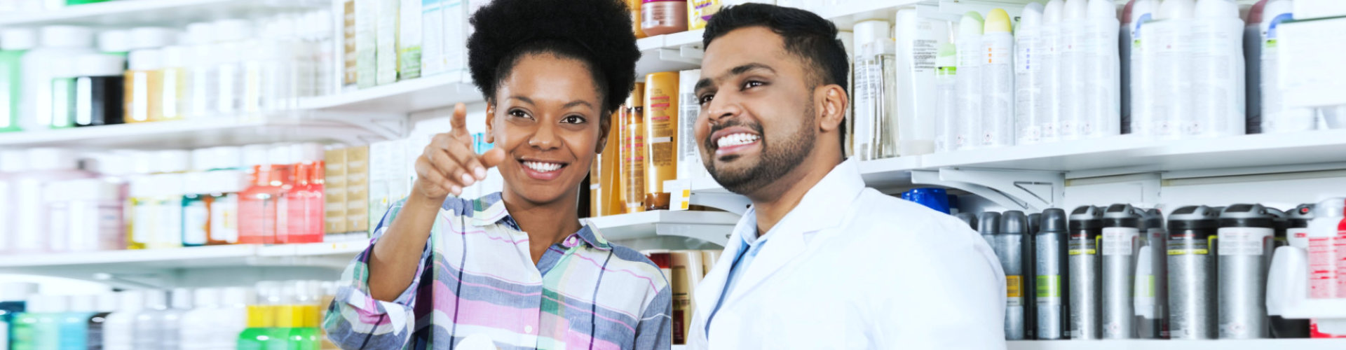 male pharmacist and adult woman smiling