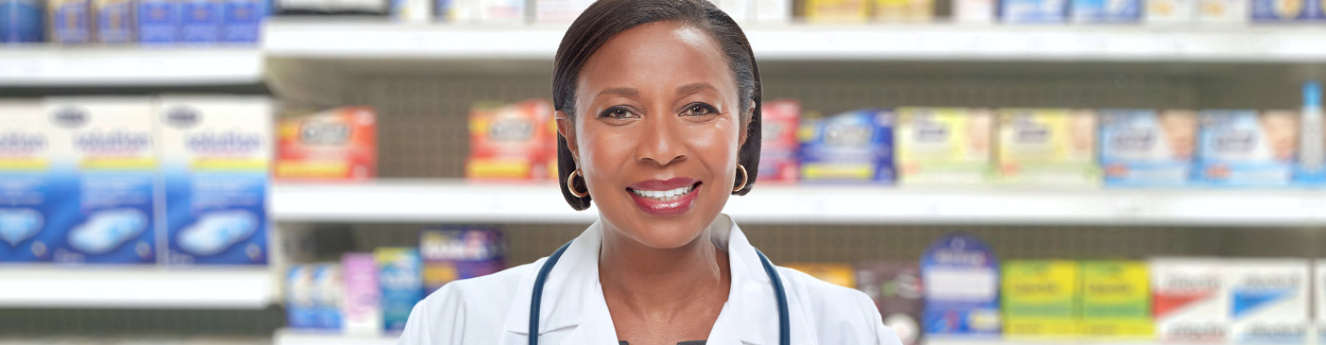 female pharmacist wearing stethoscope smiling